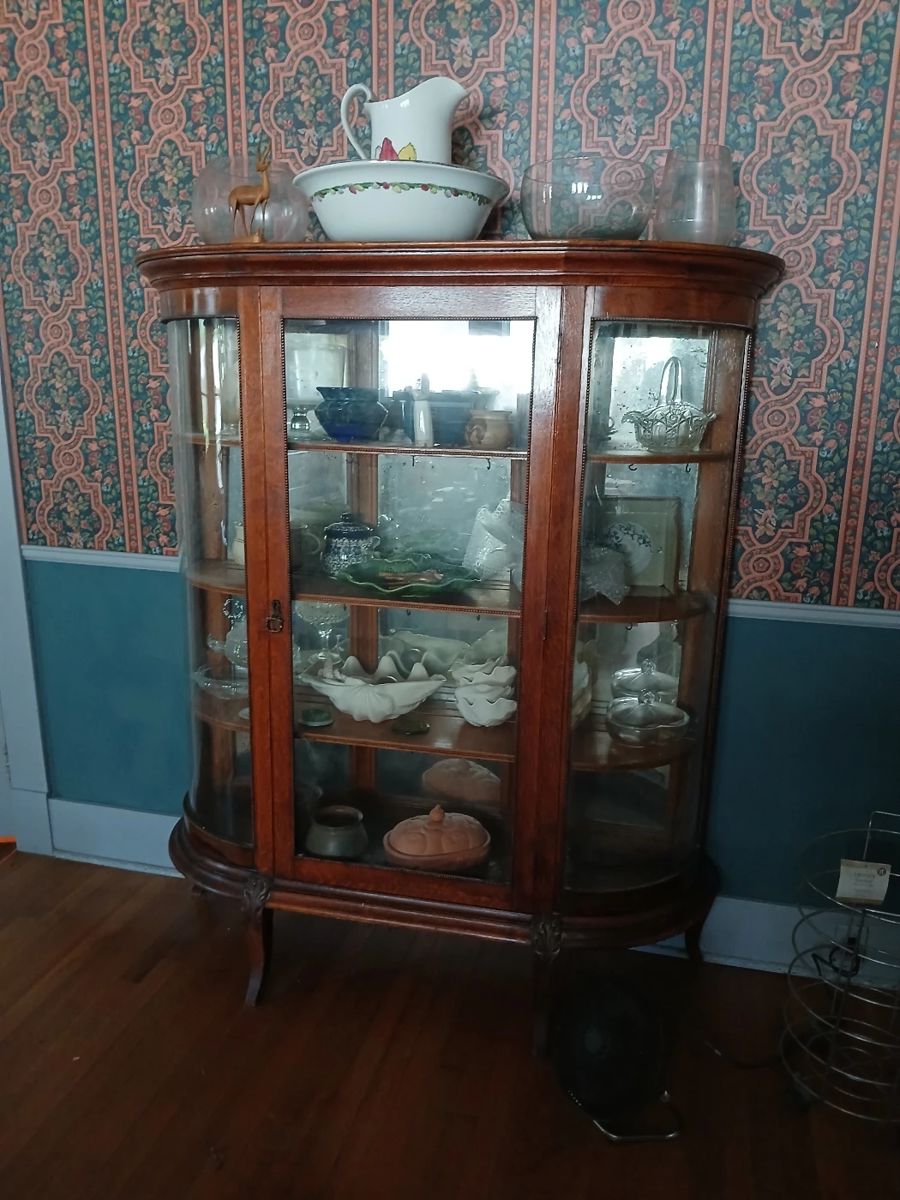 This sale includes a number of beautiful antiques, including this incredible bow front display cabinet with mercury mirror back panels!