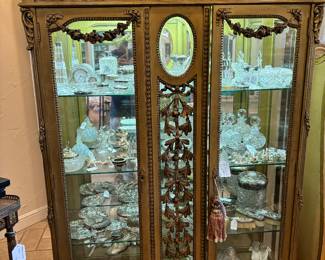 Beautiful gold gild , 2 door, mirrored back, and side panels, highly carved glass shelves, china cabinet. 
