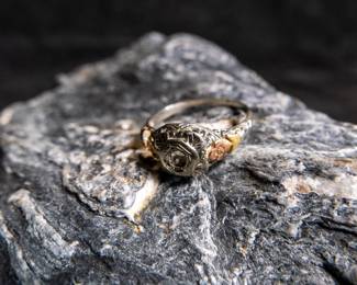 An antique 18K gold ring with damage to the band shown in photos. Also missing center stone. Approx. weight is 1.92 grams and is a size 6.5.