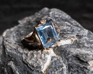 14K white gold ring with what appears to be a large Topaz and three small diamonds. Approx. weight is 7.49 grams and is a size 7.5.