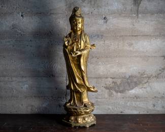An antique Chinese Guan Yin brass statue, the Buddhist goddess of compassion. She is pictured holding a brass vase. Beautiful details.