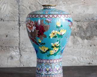 A Chinese Cloisonné enameled vase with intricate floral patterns and a decorative border. Circa late 19th/early 20th Century.