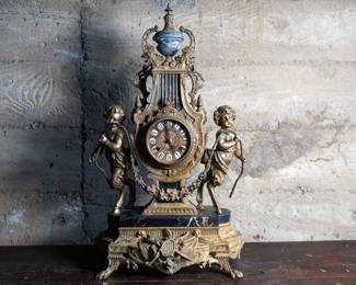 Brevettato marble ormulu mantle clock with intricate detail throughout. Contains patina and has some minor damage shown in photos. Untested.