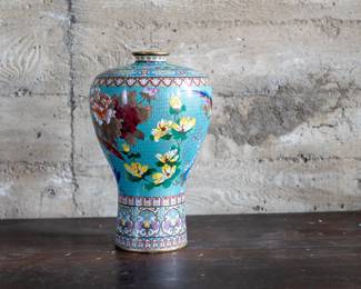 A Chinese Cloisonné enameled vase with intricate floral patterns and a decorative border. Circa late 19th/early 20th Century.