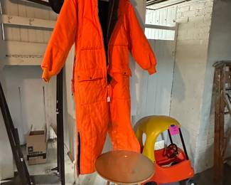 Two sets of metal bed frames, around table with glass top and a pair of orange hunters overalls!