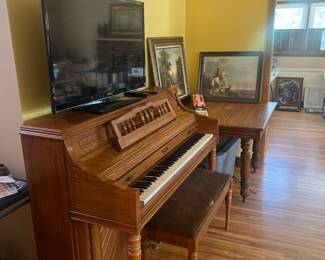 Piano and bench, table, TV, Pictures/decor