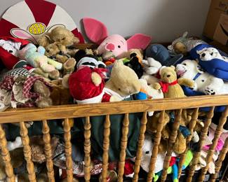 A crib full of stuffed animals!