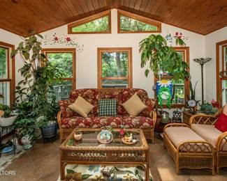 View of the sunroom from the MLS listing. All furniture and most plants are for sale!