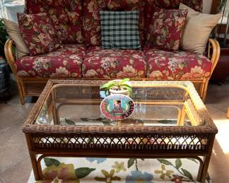 Wicker settee and glass top coffee table