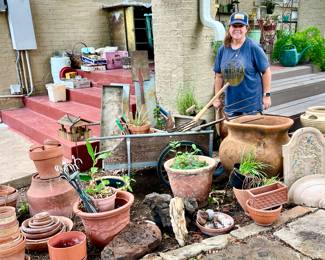fun garden area with lots of pots, succulents, vintage carts, and more!