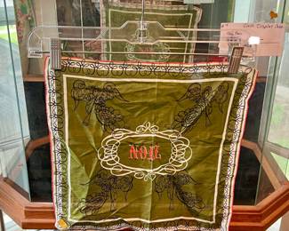 VINTAGE NOEL DESIGNER HANDKERCHIEF.  NOTICE THE GLASS DISPLAY CASE BEHIND.