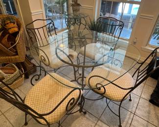 $140 Kitchen Table with 4 chairs Iron and glass top. Corners are rounded. Two chairs have rust from being out doors, two chairs have upholstery damage 
42W 29T