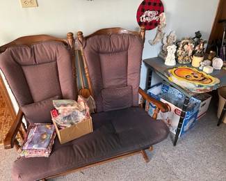 Solid oak glider with cushions.