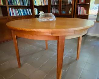 Beautiful round teak table with Hidden extension leaves
47.5 inches diameter without extensions 71 inches fully extended. Each extension is 11 and three-quarter inches.