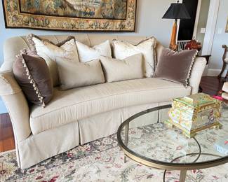 Herndon curved sofa, assorted silk and velvet pillows, heavy glass and bronze table, 10' x 14' wool rug
