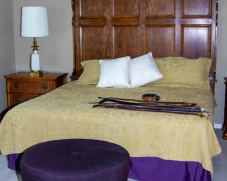 King bed with vibrant purple ottoman