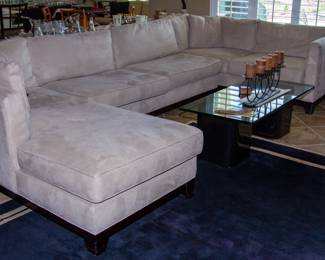 Lovely upholstered sectional couch, glass top coffee table