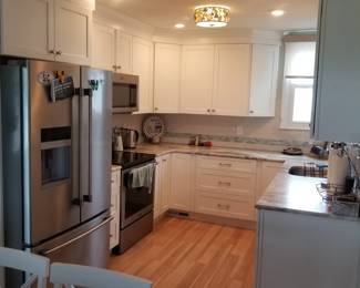 Clean, cute white kitchen with Fabuwood cabinets