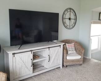 Rustic TV console; flat screen TV; large wall clock