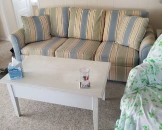Comfy blue & yellow striped couch; coffee table