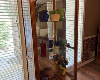 Curio cabinet front door slides, so no more trying to reach in from the sides! So easy for cleaning and for moving items around. 