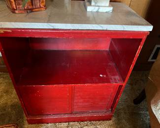 Small cabinet with sliding doors and marble top