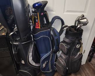 Several sets of golf clubs - some left handed