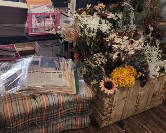 Old newspapers from important events (Kennedy, Elvis, 911), trunk, and artificial flowers