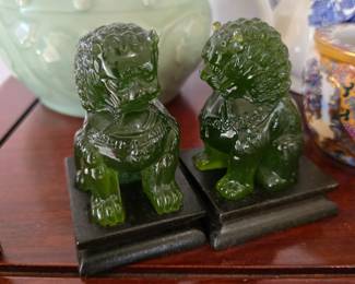 Green foo dogs on wooden stands