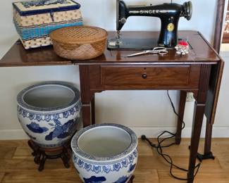 Antique Singer sewing machine in cabinet ($125); sewing accessories, two large Chinese fishbowl planter pots