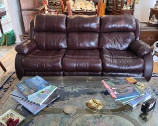 Glass coffee table with metal base; leather recliner sofa