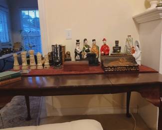 Decorative chess pieces, empty collectible liquor bottles and other items.