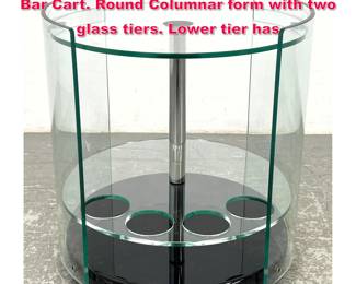 Lot 236 Designer Glass and Chrome Rolling Bar Cart. Round Columnar form with two glass tiers. Lower tier has
