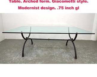 Lot 475 Heavy Iron Base Glass Top Dining Table. Arched form. Giacometti style. Modernist design. .75 inch gl
