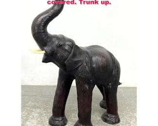 Lot 424 Figural Elephant Sculpture. Leather covered. Trunk up. 
