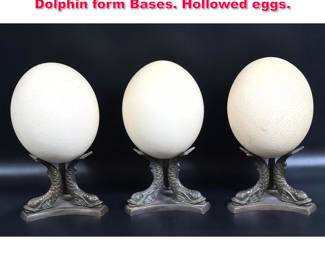 Lot 545 3 Natural Ostrich Eggs on Metal Dolphin form Bases. Hollowed eggs.