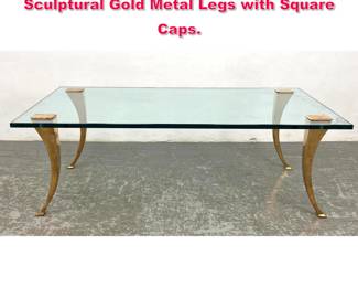 Lot 439 Decorator Glass Coffee Table. Sculptural Gold Metal Legs with Square Caps.