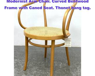 Lot 1057 THONET Blond Bentwood Modernist Arm Chair. Curved Bentwood Frame with Caned Seat. Thonet hang tag. 