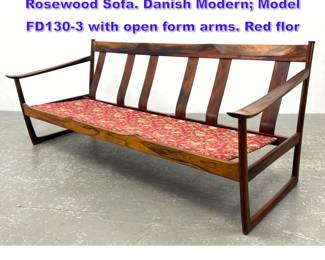 Lot 617 PETER HVIDT, ORLA MOLGAARD Rosewood Sofa. Danish Modern Model FD1303 with open form arms. Red flor