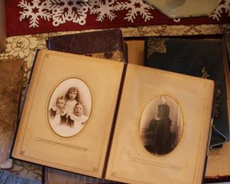 Three antique photo books full of photos