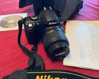 Nikon camera with a variety of lenses. 