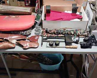 Hunting Gear Including a Buddy Rest for a Rifle, Leather Gun Holsters, Gun Cleaning Kits, Bow Hunting Arrows and More!
