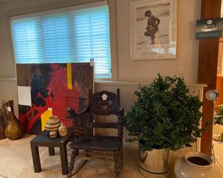 Carved Wood Gargoyle Rocking Chair, Painted Ceramic Pitcher Vase, Ceramic bowls, Red Storage Trunk, framed photos