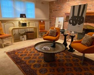 Cole Steel Orange Chair (A), Cole Steel Orange Chair (B), Moroccan Style Metal Tray Table, Thomasville furniture chrome base chairs, Waterfall console table, Brass Bouillotte Style Accent Lamp, Brass Bouillotte Style Accent Lamp, Original Munich 1972 promotional poster- as is 
