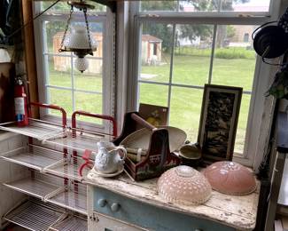 Rustic painted cupboard. A couple of metal shelf stands that look like they were used as a grocery display? Check out those light fixture domes!