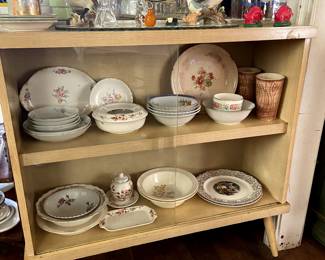 Blonde MCM glass front cabinet with antique china pieces.