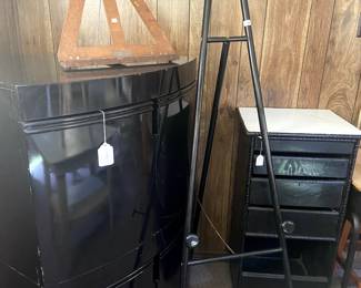 This is a black lacquer unit (actually 2 stacked) that provides great storage. We have easels of different shapes and sizes and see that painted black drawer unit??