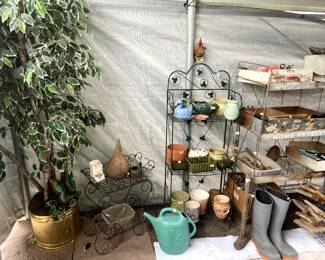 Metal plant stands, rolling cart and groovy planters! And a large ficus tree.