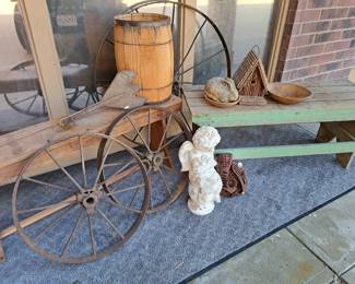 Primitive wood benches and cast iron wheels 