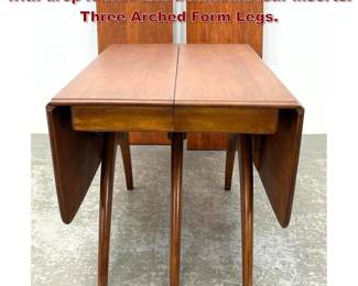 Lot 1210 Heywood Wakefield Dining table with drop leaves and additional leaf inserts. Three Arched Form Legs.